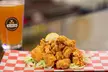 The Local Hen:10 or 20 Wings, 1 or 2 Entree, and Drinks or $100 Towards Dine-In/Takeout (Up to 48% Off) - Second Medium