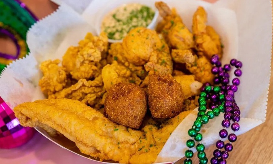 Image 11: Two Po'Boys, Meals for Two or Four With Beignets, and $50–$75 Credits