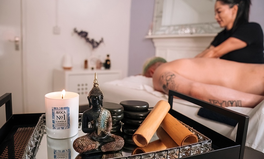 Image 1: 45-Min Sports Massage or 90-Min Massage with Hot Stones & Facial
