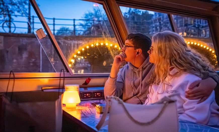 Image 21: Grachten vol lichtjes en legendes: een avondcruise door Amsterdam