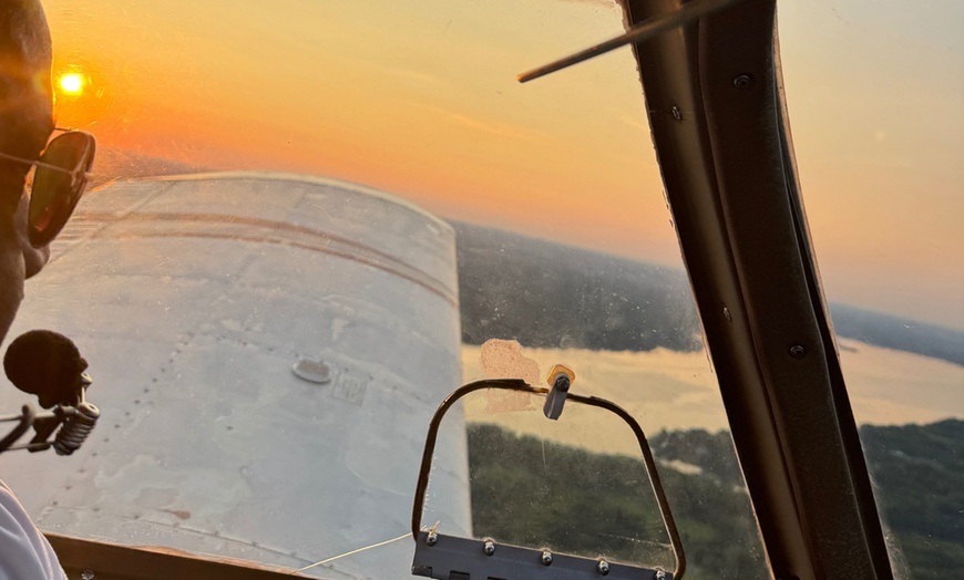 Image 1: Experience a 45-Min Discovery or One-hour Sunset Photo Flight for Two