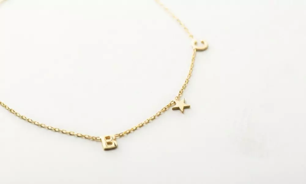 Design a unique 14K solid gold initial necklace with Becca Prado, featuring customizable options from 1 to 8 letters
