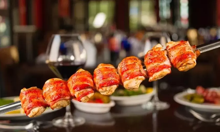Extensive Selection of Churrasca Meats and Bottle of Wine