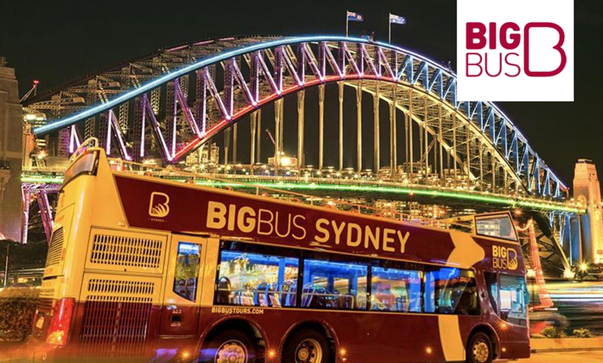 Image 1: Experience Sydney’s Landmarks Illuminated on an Open-Top Bus Tour