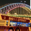 Image 1: Experience Sydney’s Landmarks Illuminated on an Open-Top Bus Tour