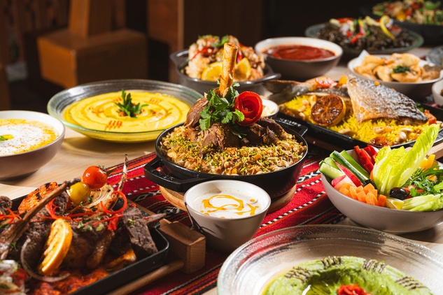 A beautifully arranged spread of traditional Iftar buffet dishes, including fresh salads, hot main courses, and refreshing Ramadan juices.