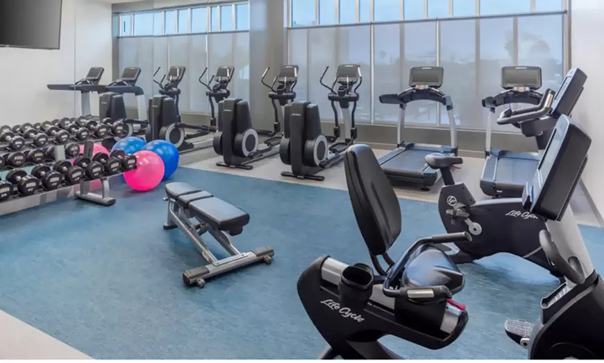 24‑hour fitness center with cardio equipment & free weights