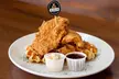The Local Hen:10 or 20 Wings, 1 or 2 Entree, and Drinks or $100 Towards Dine-In/Takeout (Up to 48% Off) - Second Medium