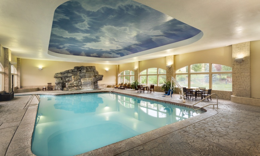 Image 8: Cozy alpine rooms, heated pool, and mountain views