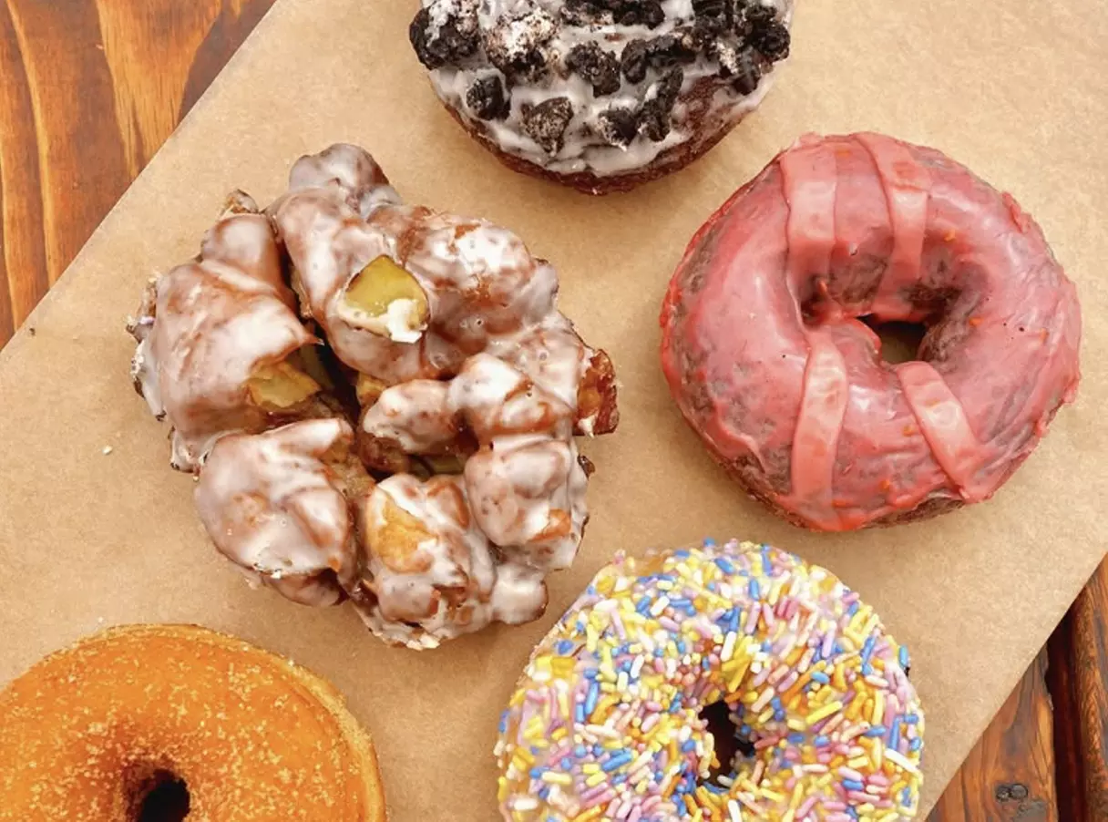 Up to a Dozen Donuts, 4 Donuts & 2 Drinks or $50 to Spend