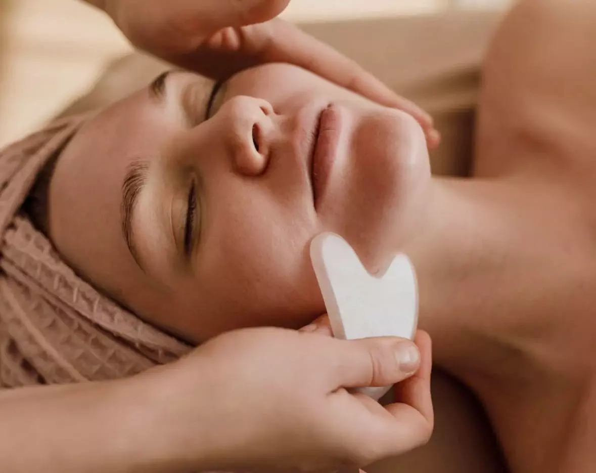 Indulge in Esthetics by Faith's One or Three Sessions Gua Sha & Cupping Red Light Therapy (Up to 70% Off) - Primary Image