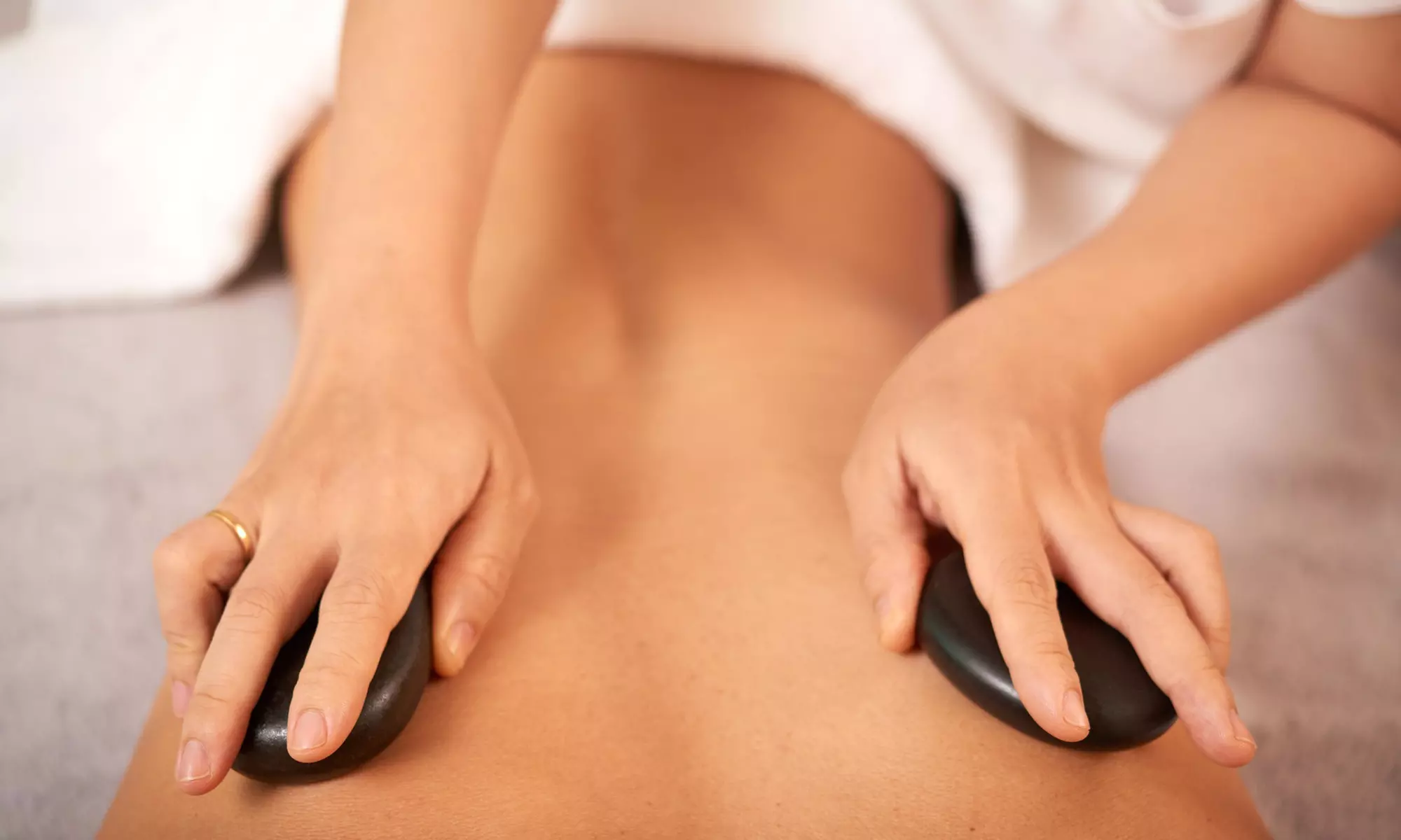 Melt Away Stress and Tension with a Soothing Hot Stone Massage at UP Beauty Lounge (Up to 60% Off) - Primary Image