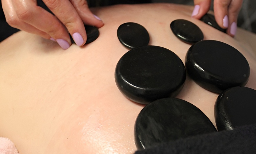 Image 2: One, Three or Five Hot Stone Massage and Back Facial Treatments
