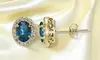 London Blue & White Topaz Oval Halo Stud Earrings in Yellow Flash 925 Silver