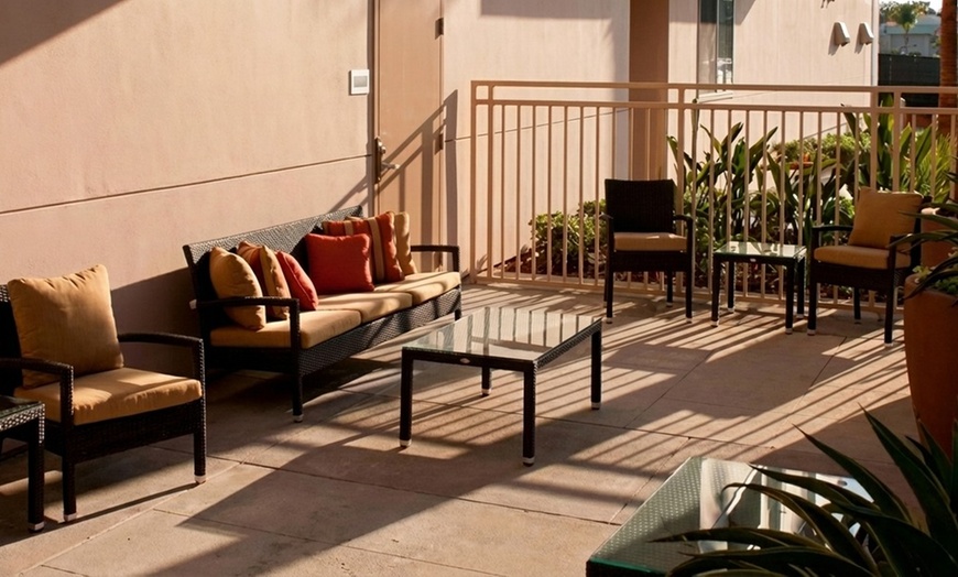 Image 2: Courtyard-Style Hotel Retreat with Outdoor Pool & Bistro Dining