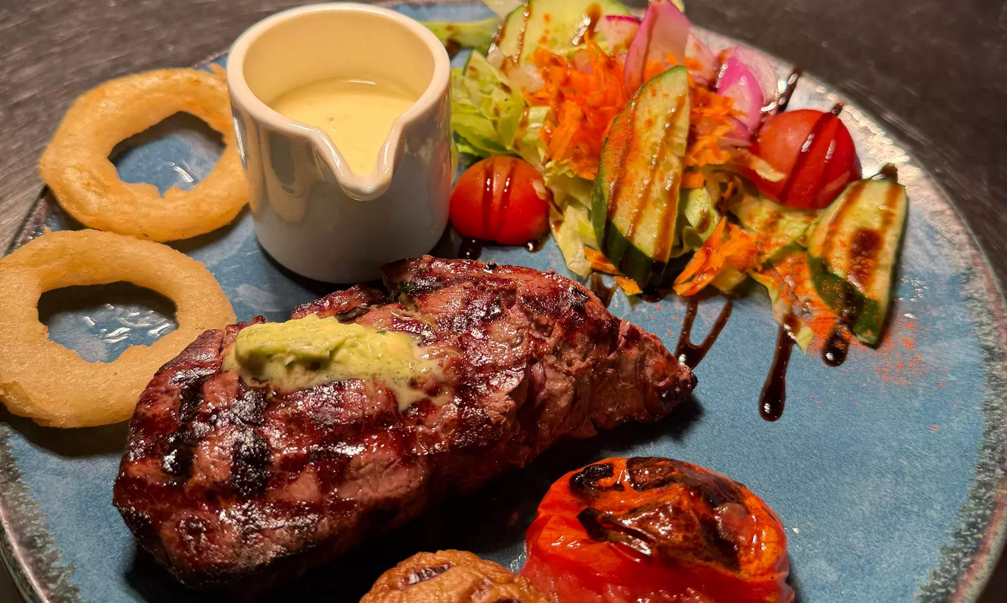 Savor Delicious Steak with Fries, Salad, Sauce and a Glass of Wine