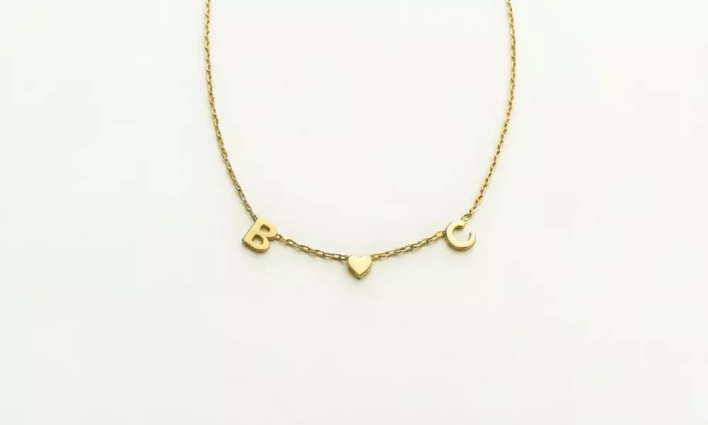 Design a unique 14K solid gold initial necklace with Becca Prado, featuring customizable options from 1 to 8 letters