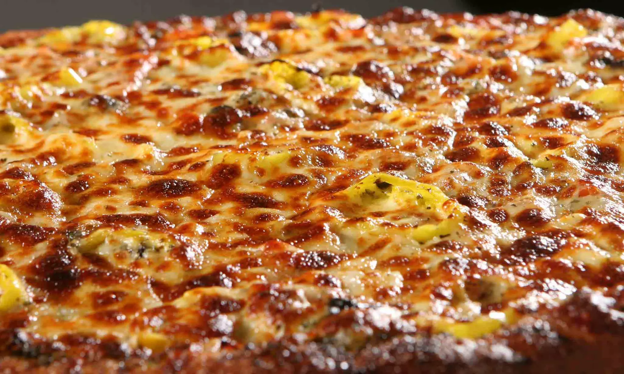 Medium or Large Specialty Pizza with Salad and Two Drinks at DeCheco's Pizzeria (40% Off) - Primary Image