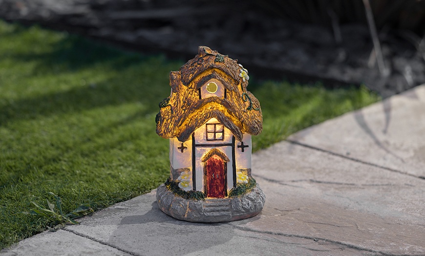 Image 1: One or Two Thatched Cottage Solar-Powered Fairy House Ornaments