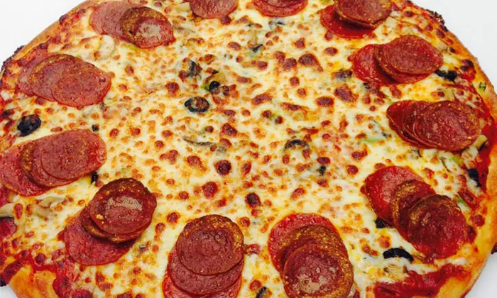 Medium or Large Specialty Pizza with Salad and Two Drinks at DeCheco's Pizzeria (40% Off) - Second Medium