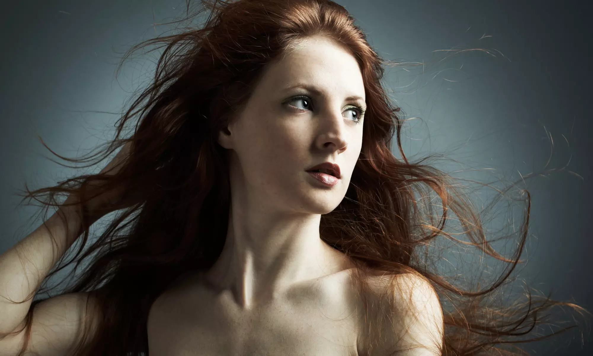 Haircut and Blow-Dry with Option for Highlights, Retouch, or Brow Wax at Masquerade Salon (Up to 56% Off) - Primary Image