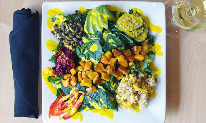 Food and Drinks for Dinner at Peoples Organic - Calhoun Square/Uptown (Up to 47% Off). Two Options Available. - Primary Image