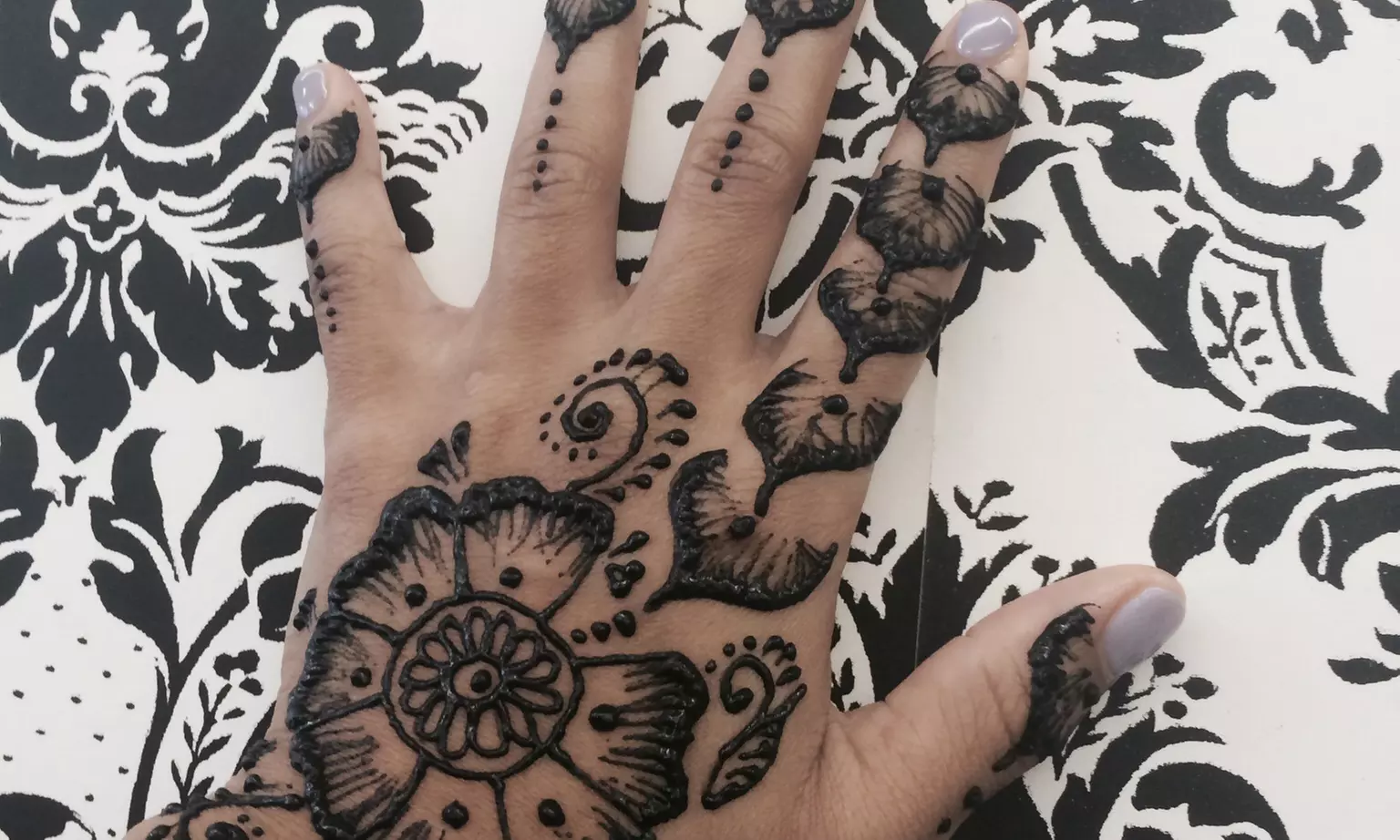 Enhance your style at Nail'd It! with one or three henna tattoos, offering artistic flair in black or brown shades, up to 50% off - Primary Image