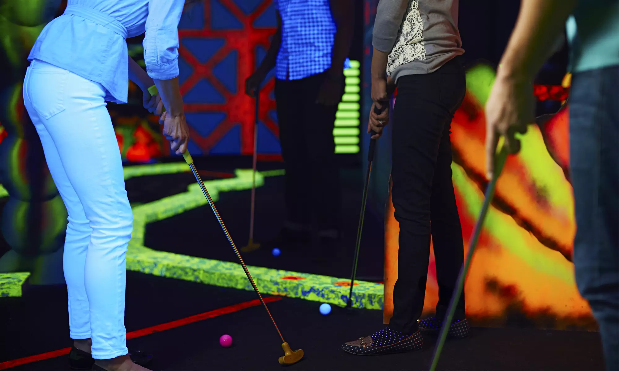 Two Rounds of Black-Light Mini Golf with Chips and Drinks for Two or Four at Cosmic Mini Golf (Up to 57% Off) - Primary Image