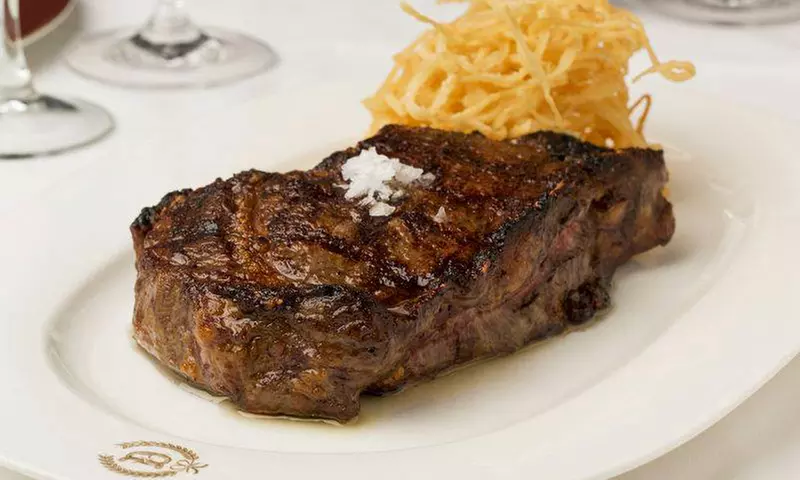 Steak-House Cuisine at Delmonico's Kitchen (Up to 37%Off). Two Options Available.  - Primary Image