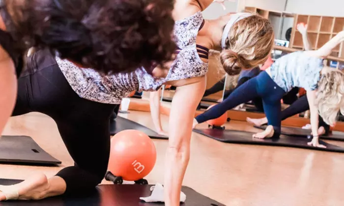Discover Barre3 Tulsa's Yoga-Barre Classes with 2 Week Unlimited, featuring a unique blend of yoga, pilates, and ballet barre up to 40% - Primary Image