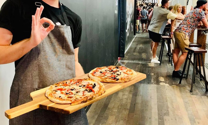 Image 2: Axe Throwing, Pizza & Drink Package at Maniax Axe Throwing Brisbane