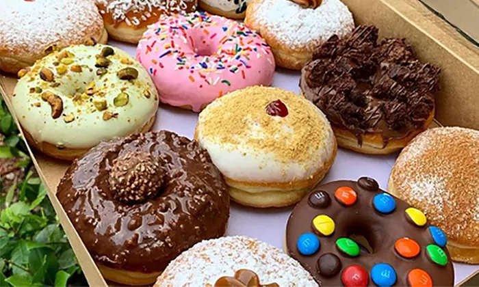 One Dozen of Glazed or Specialty Donuts or Two Donuts at Maxi Donas (Up to 41% Off) - Primary Image