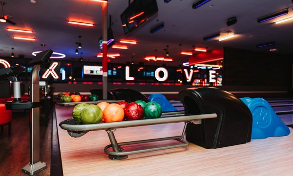 Sleek bowling lanes with dynamic lighting and video walls