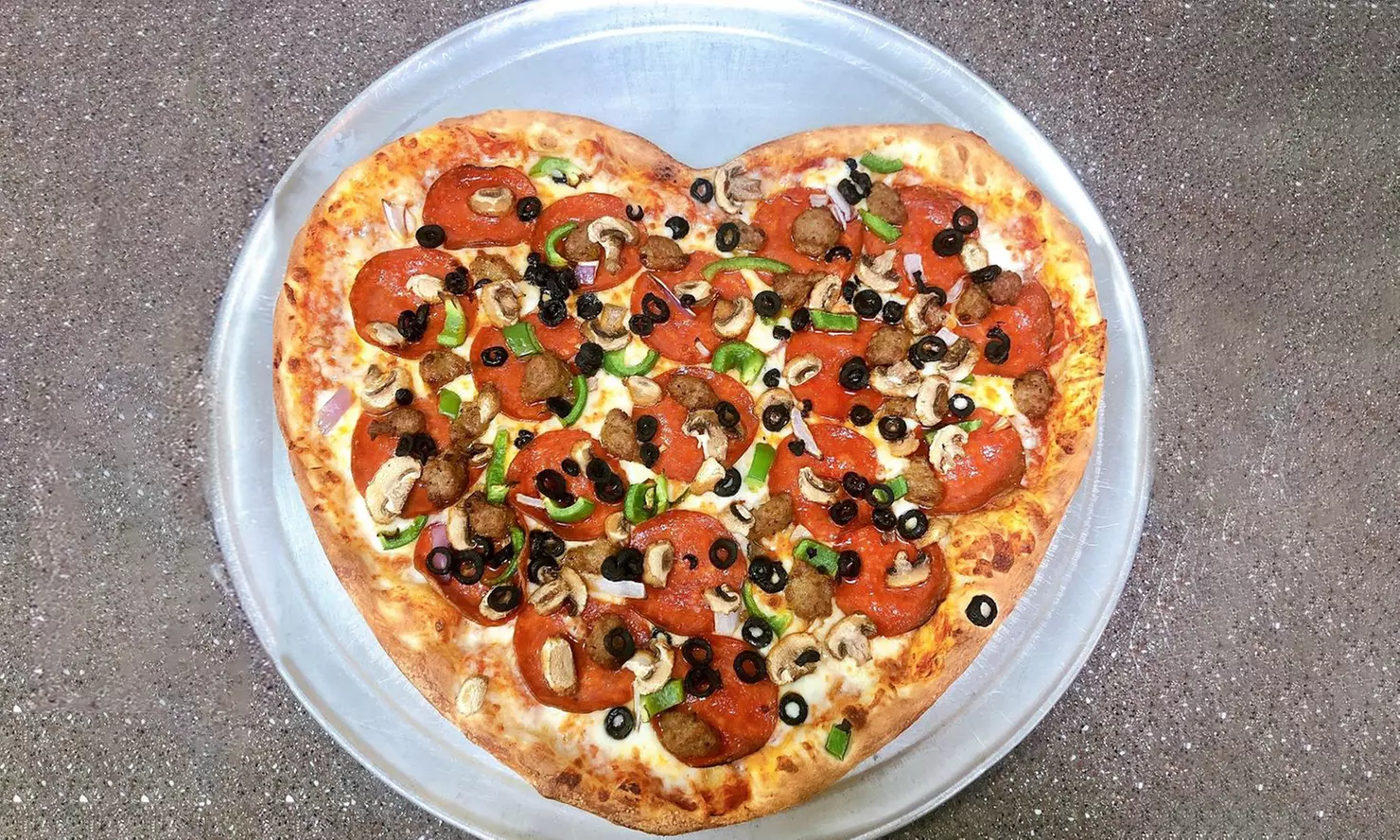Pizza, Calzones, Wings, and More at Pizza Express (Up to 50% Off). Two Options Available. - Primary Image