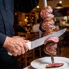 Image 2: Extensive Selection of Churrasca Meats and Bottle of Wine