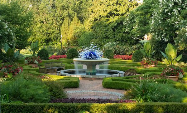 Manicured formal garden with a central fountain and sculptural glass centerpiece at Atlanta Botanical Garden