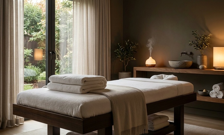 Image 2: Deluxe, Therapeutic, or Combo Body-Work Package with Essential Oil, Hot Towel, and Hot Stone Treatment. Save Up to 61%
