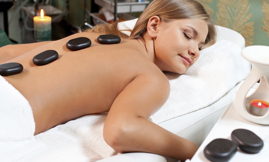 Image 1: 60-Minute Hot Stone Whole Body Massage with Coconut Oil for One or Two