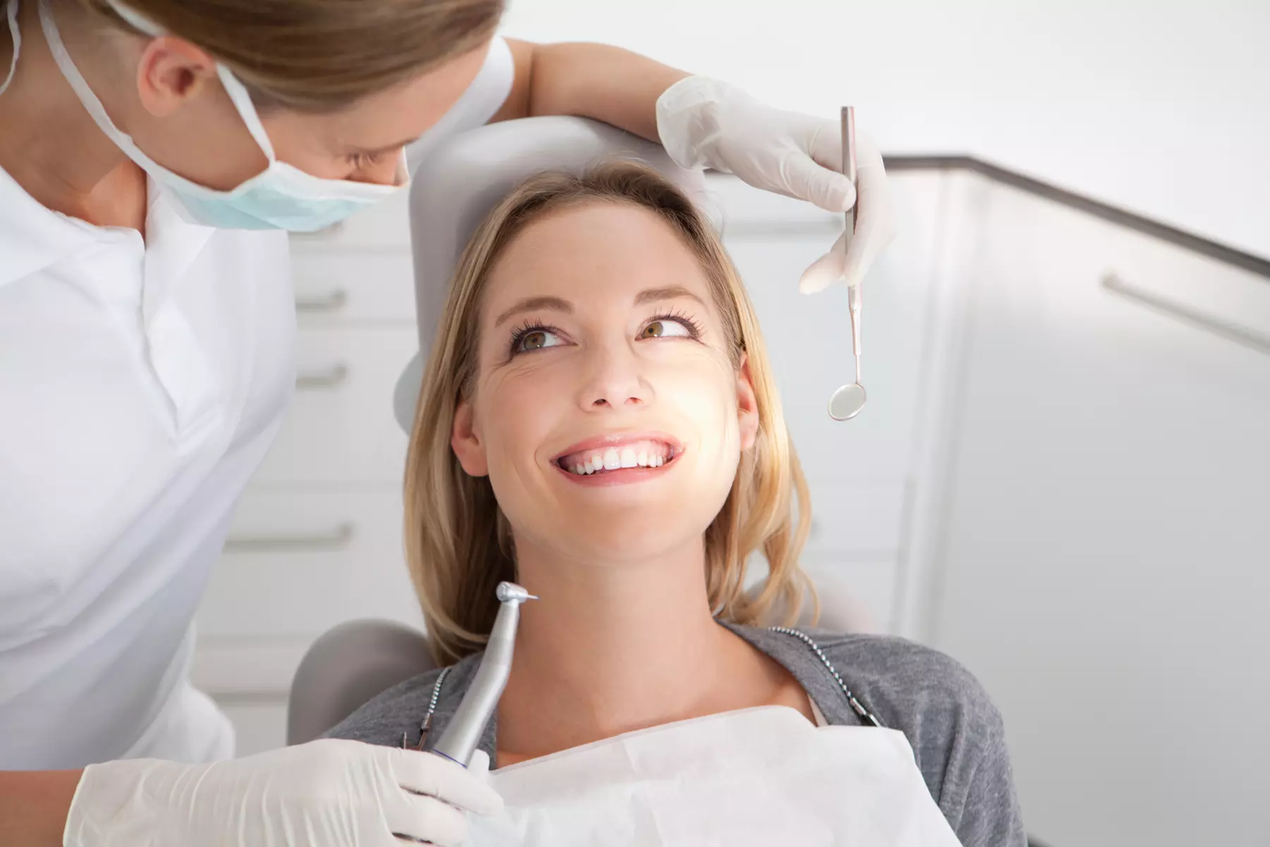 Implant Per Tooth or Comprehensive Dental Exam, Regular Cleaning and Full Set of X-Rays ( Up to 75% Off ) - Primary Image