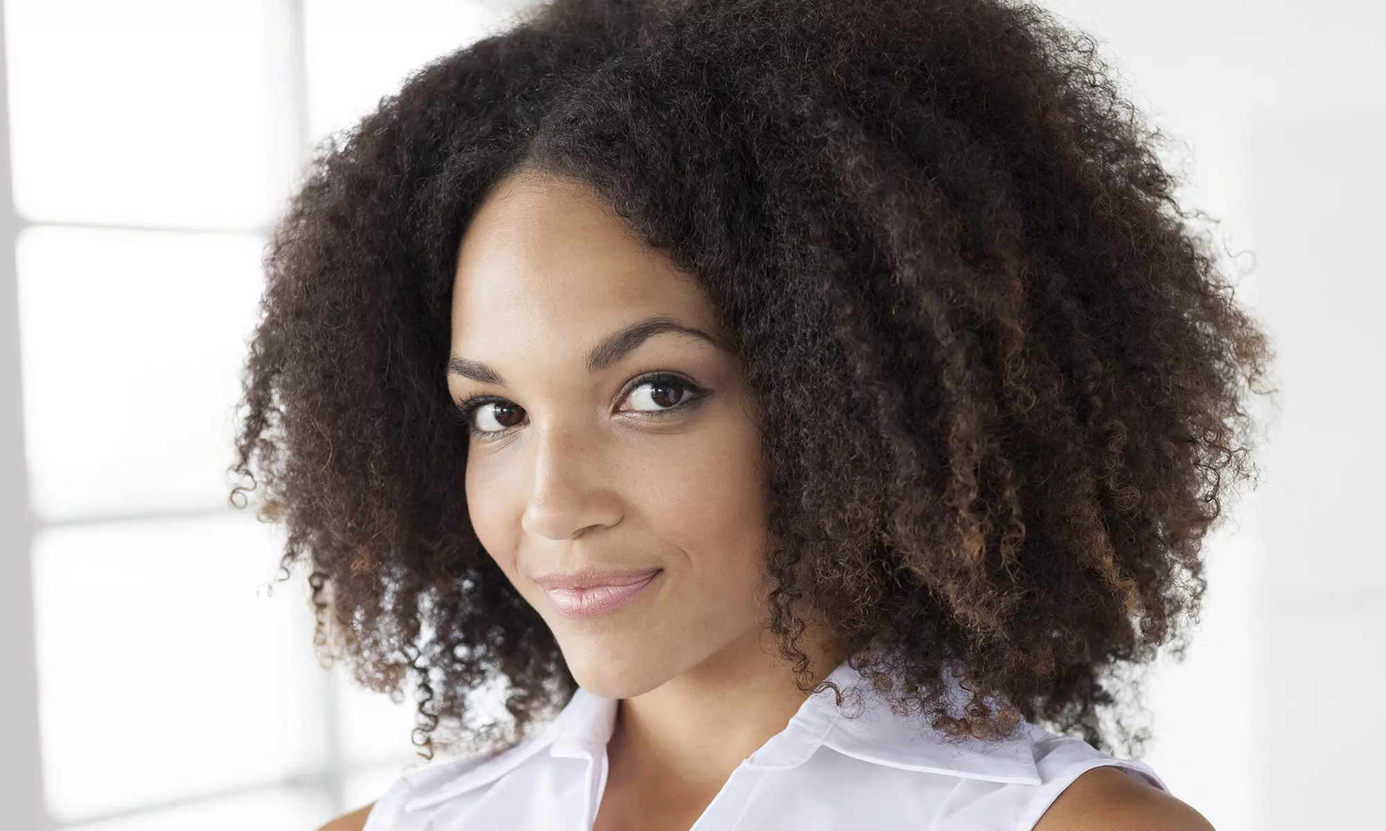 Relaxer, Press and Curl, Body Waves, or Innovation Curls or Silk 2 Curls at Afro Hair Styling (Up to 51% Off) - Primary Image