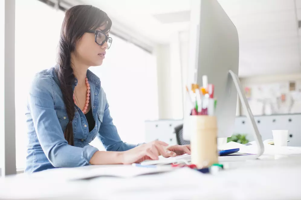 Person teaching English online with a laptop and headset