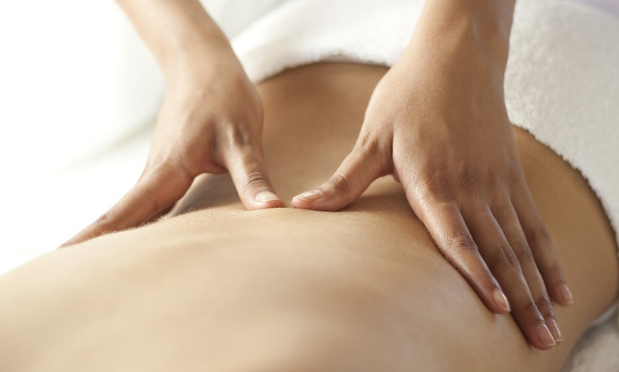 Image 1: Relax & Unwind w/ Swedish, Deep‑Tissue, Hot Stone, Cupping or Combination Massage at (Up to 50% Off)