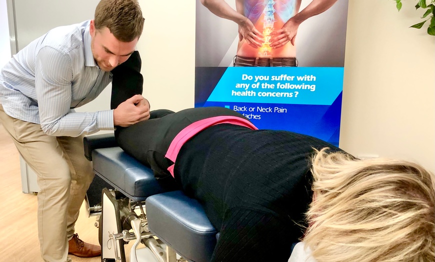 Image 3: Initial Consultation, Exam, and Adjustment by Qualified Chiropractors 