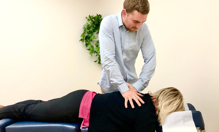 Image 1: Initial Consultation, Exam, and Adjustment by Qualified Chiropractors 