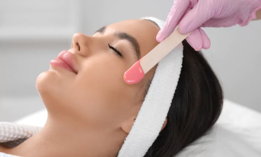 Image 1: Achieve Glowing Skin with One Full Face Wax Service for Ladies!