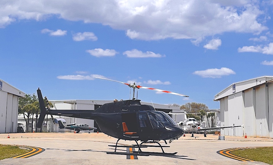 Image 1: Helicopter Tour Over Beaches and Cityscapes