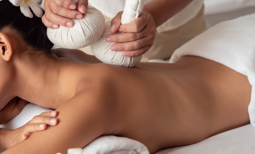 Image 1: Experience a 60-Minute Thai Massage with Hot Stones or Essential Oils