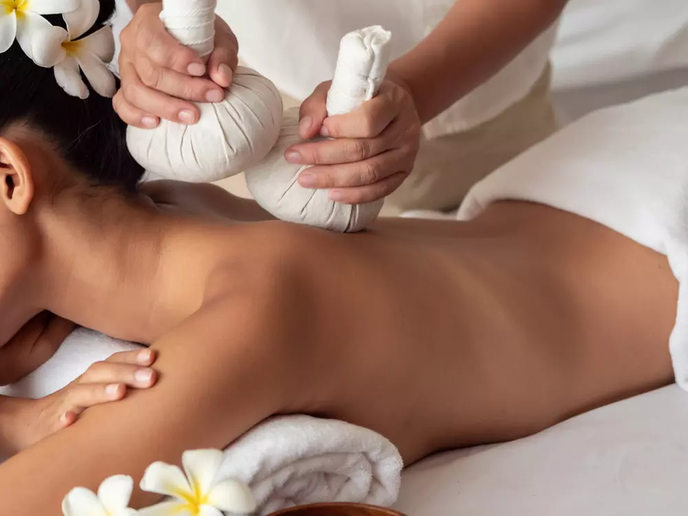 Experience a 60-Minute Thai Massage with Hot Stones or Essential Oils