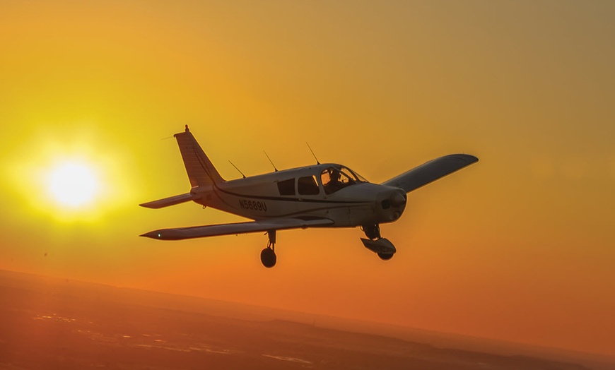 Image 1: One Romantic Sunset Flight or Discovery Flight Class for One or Two 