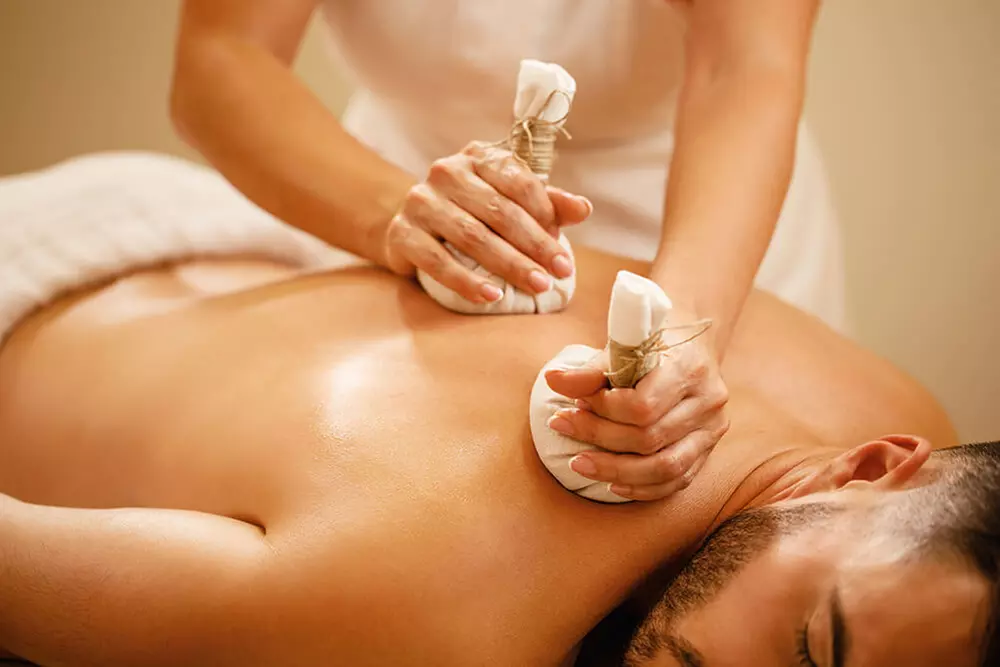 Experience a 60-Minute Thai Massage with Hot Stones or Essential Oils